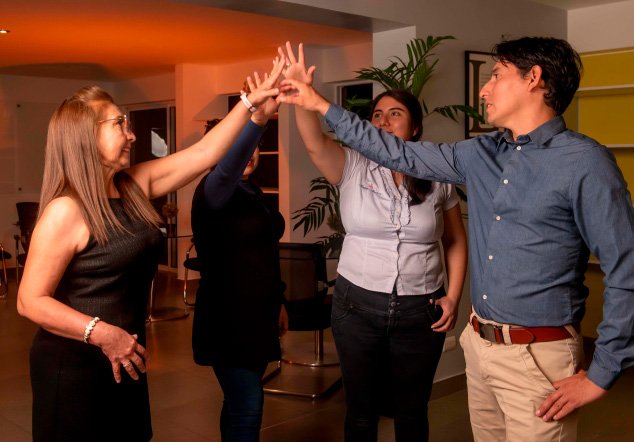 disenadora-de-vestidos-en-gamarra-empresarios-llenos-de-alegria-unen-sus-manos-equipo
